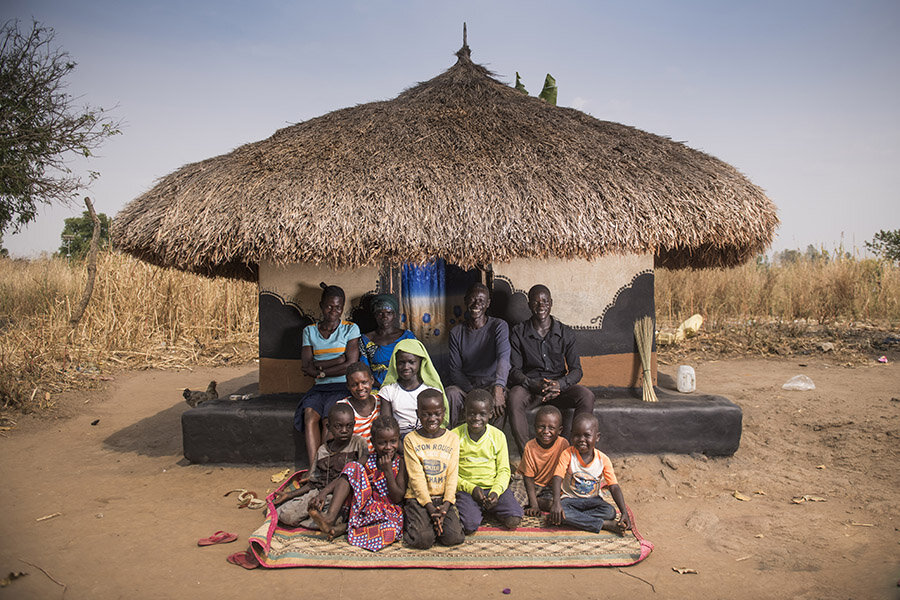Willy and his family outside their home in the Lobule refugee settlement. Refugees can not own land in Uganda, but land is provisionsed to each refugee family for mainly agricultural use.
