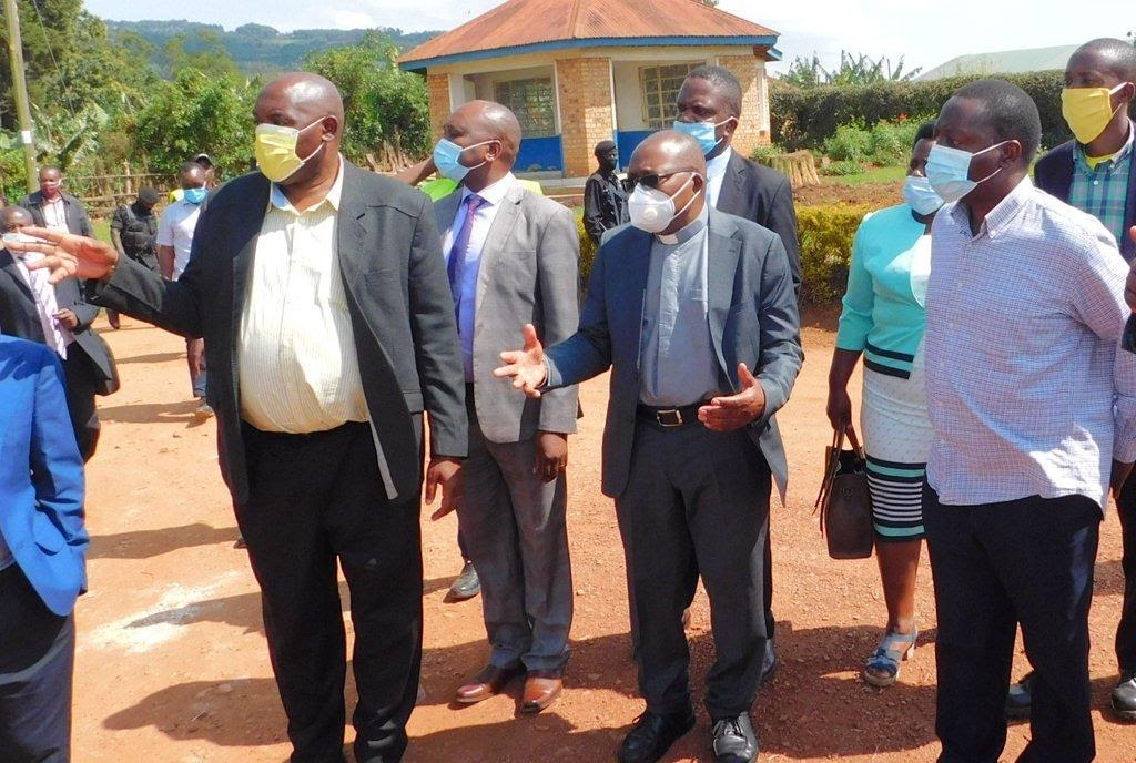 Roads Upgrade in Kabale Municipality: Dr. Chris Baryomunsi (left), Bishop Callist Rubaramira (center) and Mr. David Bahati (right) together with other officials at Rushoroza road Kabale.